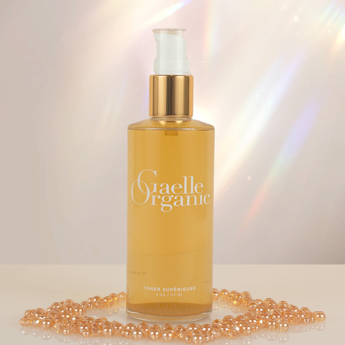 The best natural pore minimizer with shiny golden beads and a prism background