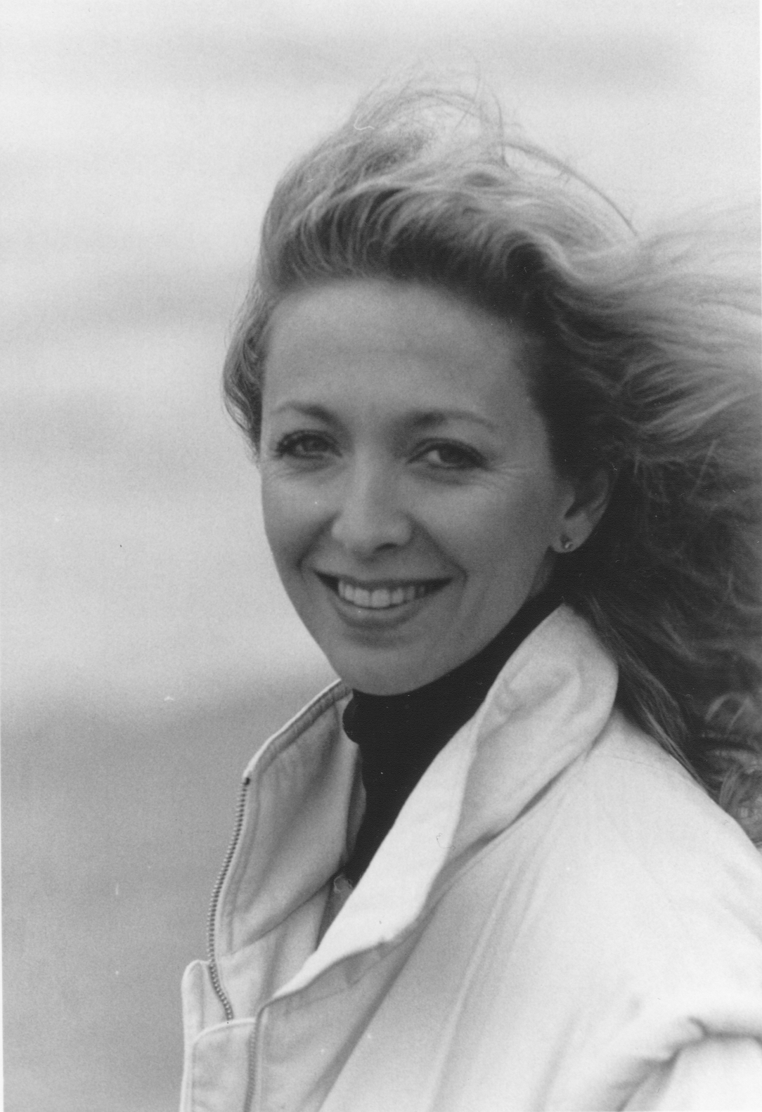 Gaelle with windswept hair at the beach
