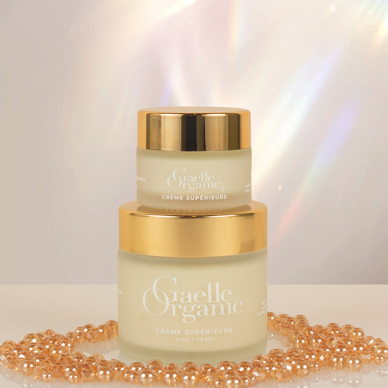 Creme Superieure, the best moisturizer for dry aging skin, in full and travel sizes, with gold beads and a prism background