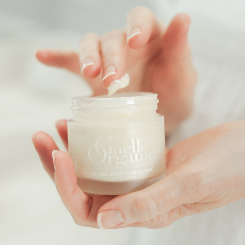 Hands holding Creme Superieure, the best organic moisturizer for mature dry skin