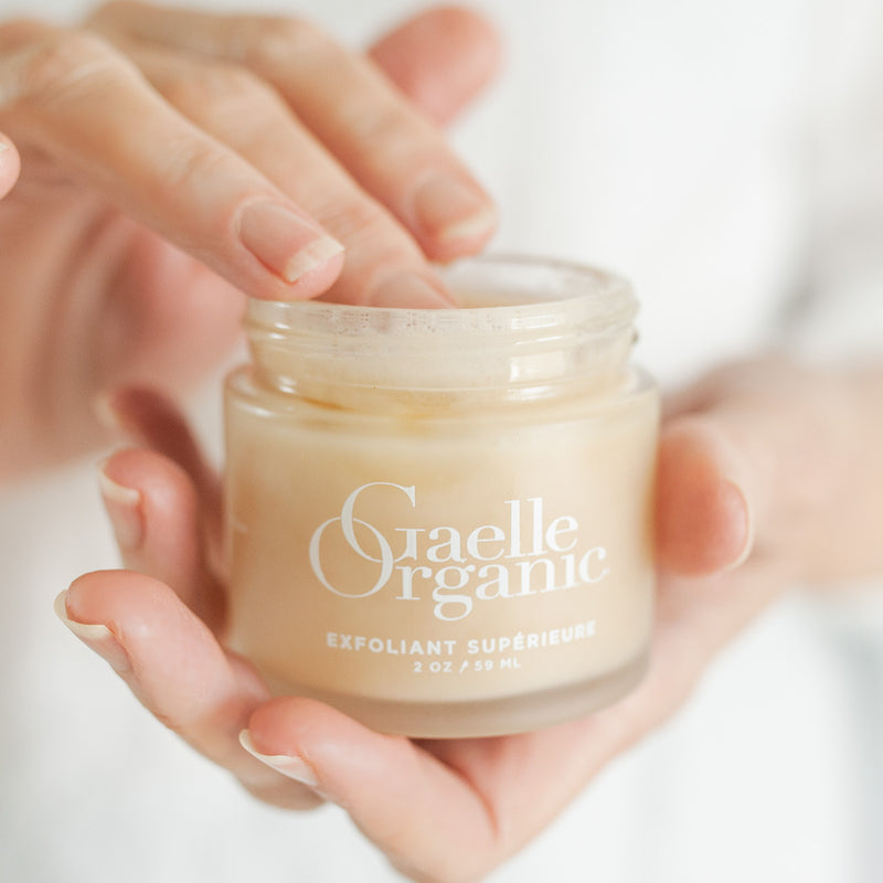 Hands holding Exfoliant Superieure, a natural exfoliator ideal for mature skin