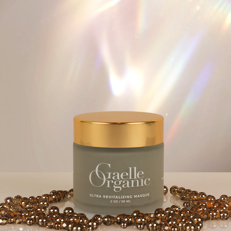 The best mask for fine lines and mature skin, Ultra Revitalizing Masque on a light background with dark shiny beads.