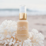 Serum Superieure, the best organic brightening serum for dry skin, resting in white coral on the beach
