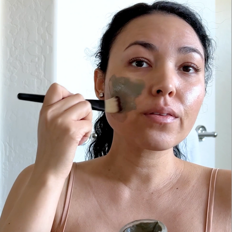 Model applying Ultra Clarifying Masque to calm breakouts