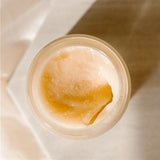 An open jar of Exfoliant Superieure, the best natural exfoliator for dry skin, on a soft ivory background