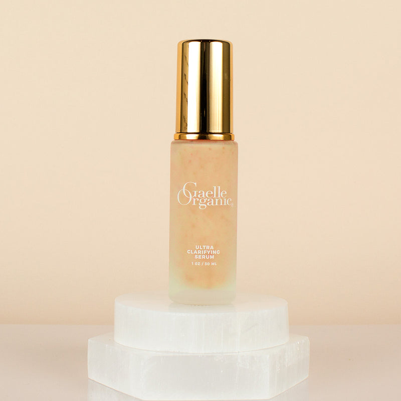 Ultra Clarifying Serum, the best organic serum for calming breakouts, on a white stone pedestal